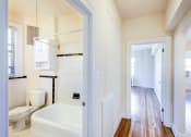 Thumbnail 26 of 29 - hallway view of living area, bedroom and bathroom at the frontenac apartments in van ness washington dc