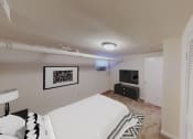 Thumbnail 8 of 15 - bedroom with bed, plush carpeting, dresser and tv at 1818 riggs apartments washington dc
