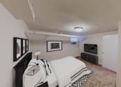 Thumbnail 7 of 15 - bedroom with bed, plush carpeting, dresser and tv at 1818 riggs apartments washington dc