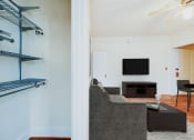 Thumbnail 4 of 15 - living area with sofa, coffee table, hardwood floors and large closet at 1818 riggs apartments in washington dc