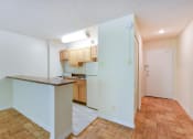 Thumbnail 18 of 39 - kitchen with wood cabinetry, gas range and breakfast bar at twin oaks apartments columbia heights washington dc