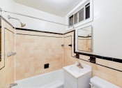 Thumbnail 27 of 27 - bathroom with tub, vanity, toilet and tile details at  2629 39th Street apartments in washington dc