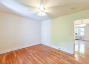 Thumbnail 21 of 27 - vacant bedroom with hardwood flooring, ceiling fan and view of living area  at  2629 39th Street apartments in washington dc