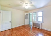 Thumbnail 22 of 27 - vacant bedroom with hardwood flooring, ceiling  fan and large windows  at  2629 39th Street apartments in washington dc