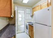 Thumbnail 9 of 27 - kitchen with tile flooring, wood cabinetry, energy efficient appliances, gas range and window at  2629 39th Street apartments in washington dc