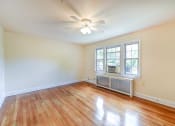 Thumbnail 12 of 27 - vacant living area with hardwood flooring, ceiling fan, and large windows  at  2629 39th Street apartments in washington dc