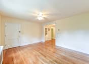 Thumbnail 14 of 27 - vacant living area with hardwood floorings, ceiling fan and view of hallway  at  2629 39th Street apartments in washington dc