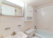 Thumbnail 10 of 39 - bathroom with toilet, vanity, tub, and medicine cabinet at twin oaks apartments columbia heights washington dc