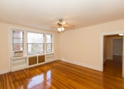 Thumbnail 13 of 26 - vacant living area with hardwood flooring, ceiling fan, and large windows at 2701 Connecticut apartments in washington dc