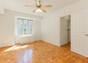 Thumbnail 16 of 40 - vacant bedroom with hardwood flooring and ceiling fan at 2800 woodley road apartments in woodley park washington dc