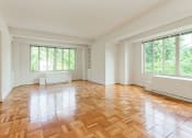 Thumbnail 17 of 40 - vacant living area with hardwood flooring and large windows at 2800 woodley road apartments in northwest washington dc