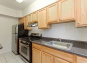 Thumbnail 13 of 40 - kitchen with stainless steel appliances and wood cabinetry at 2800 woodley road apartments in washington dc