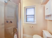 Thumbnail 24 of 26 - bathroom with walk in shower, vanity, large mirror, tile details and window at 2800 ontario road apartments in washington dc