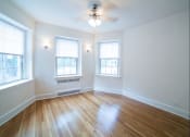 Thumbnail 13 of 26 - vacant living area with hardwood floors, large windows and ceiling fan at 2800 ontario road apartments in washington dc