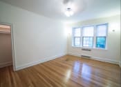 Thumbnail 14 of 26 - vacant bedroom with hardwood flooring and ceiling fan at 2800 ontario road apartments in washington dc