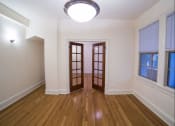 Thumbnail 16 of 26 - vacant living area with modern lighting, hardwood flooring, large windows and french doors at 2800 ontario road apartments in washington dc