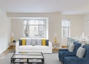 Thumbnail 4 of 40 - living area with sofa, coffee table and large windows at 2800 woodley apartments in washington dc