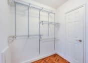 Thumbnail 18 of 40 - large closet with hardwood flooring and modern shelving at 2800 woodley road apartments in woodley park washington dc