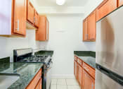 Thumbnail 3 of 40 - Renovated kitchen with stainless steel appliances and oak cabinetry at 2800 woodley road apartments in woodley park washington dc