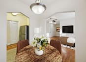 Thumbnail 4 of 21 - A dining room with a wooden table and chairs.