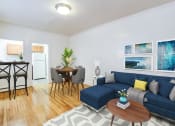 Thumbnail 5 of 17 - living area with sofa, coffee table, and views of kitchen and dining areas at 3213 wisconsin apartments in washington dc