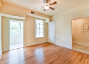 Thumbnail 12 of 39 - vacant living area with hardwood flooring, large windows and ceiling fan  at twin oaks apartments columbia heights washington dc
