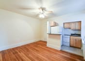Thumbnail 13 of 21 - vacant living area with hardwood flooring, ceiling fan and view of kitchen at the cortland apartments in washington dc