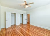 Thumbnail 10 of 26 - vacant bedroom with ceiling fan, hardwood floors, and large closets at 2701 connecticut ave apartments in washington dc