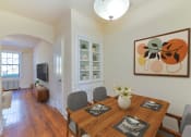 Thumbnail 2 of 16 - a dining room with a wooden table and chairs