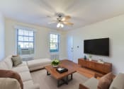 Thumbnail 4 of 16 - a living room with a couch and a coffee table