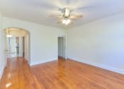 Thumbnail 5 of 16 - vacant living area with hardwood flooring, ceiling fan and view of kitchen at 4020 calvert street apartments in washington dc