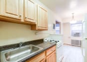 Thumbnail 4 of 18 - kitchen with gas range, sink, refrigerator and view of dining area at 4031 davis place apartments in washington dc