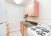 Thumbnail 2 of 18 - kitchen with gas range, sink and refrigerator at 4031 davis place apartments in washington dc