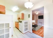 Thumbnail 3 of 18 - kitchen with gas range, wood cabinetry and view of living area at 4031 davis place apartments in washington dc