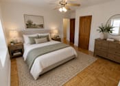 Thumbnail 3 of 19 - A bedroom with a large bed, a wooden dresser, and a ceiling fan.