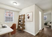 Thumbnail 3 of 24 - A room with a desk, chair, and a painting on the wall.