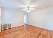 Thumbnail 16 of 21 - vacant living area with hardwood flooring and ceiling fan at the cortland apartments in washington dc