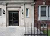 Thumbnail 21 of 21 - exterior entrance of brick apartment building at 6100 14th street apartments in washington dc