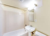 Thumbnail 9 of 18 - bathroom with toilet, tub, sink and mirror at 734 longfellow street apartments in washington dc