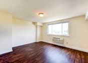 Thumbnail 16 of 18 - vacant living area with hardwood flooring and large windows at 734 longfellow street apartments in washington dc