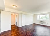 Thumbnail 15 of 18 - vacant living area with hardwood flooring and large windows at 734 longfellow street apartments in washington dc