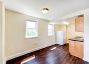 Thumbnail 14 of 18 - kitchen with hardwood floors, refrigerator and large windows at 734 longfellow street apartments in washington dc