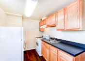 Thumbnail 13 of 18 - kitchen with hardwood floors, refrigerator and gas range at 734 longfellow street apartments in washington dc