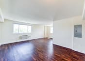 Thumbnail 17 of 18 - vacant living area with hardwood flooring and large windows at 734 longfellow street apartments in washington dc