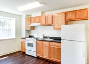 Thumbnail 3 of 18 - kitchen with hardwood floors, refrigerator and gas range at 734 longfellow street apartments in washington dc
