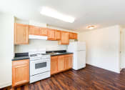 Thumbnail 2 of 18 - kitchen with hardwood floors, refrigerator and gas range at 734 longfellow street apartments in washington dc