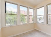 Thumbnail 14 of 39 - vacant sunroom with hardwood floors and large windows at twin oaks apartments columbia heights washington dc
