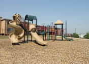 Thumbnail 29 of 29 - A playground with a slide, swings, and a climbing frame.