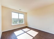 Thumbnail 6 of 21 - vacant living area with hardwood floors and large window at archer park apartments in Washington dc