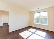 Thumbnail 8 of 21 - vacant living area with hardwood flooring and large windows at archer park apartments in washington dc